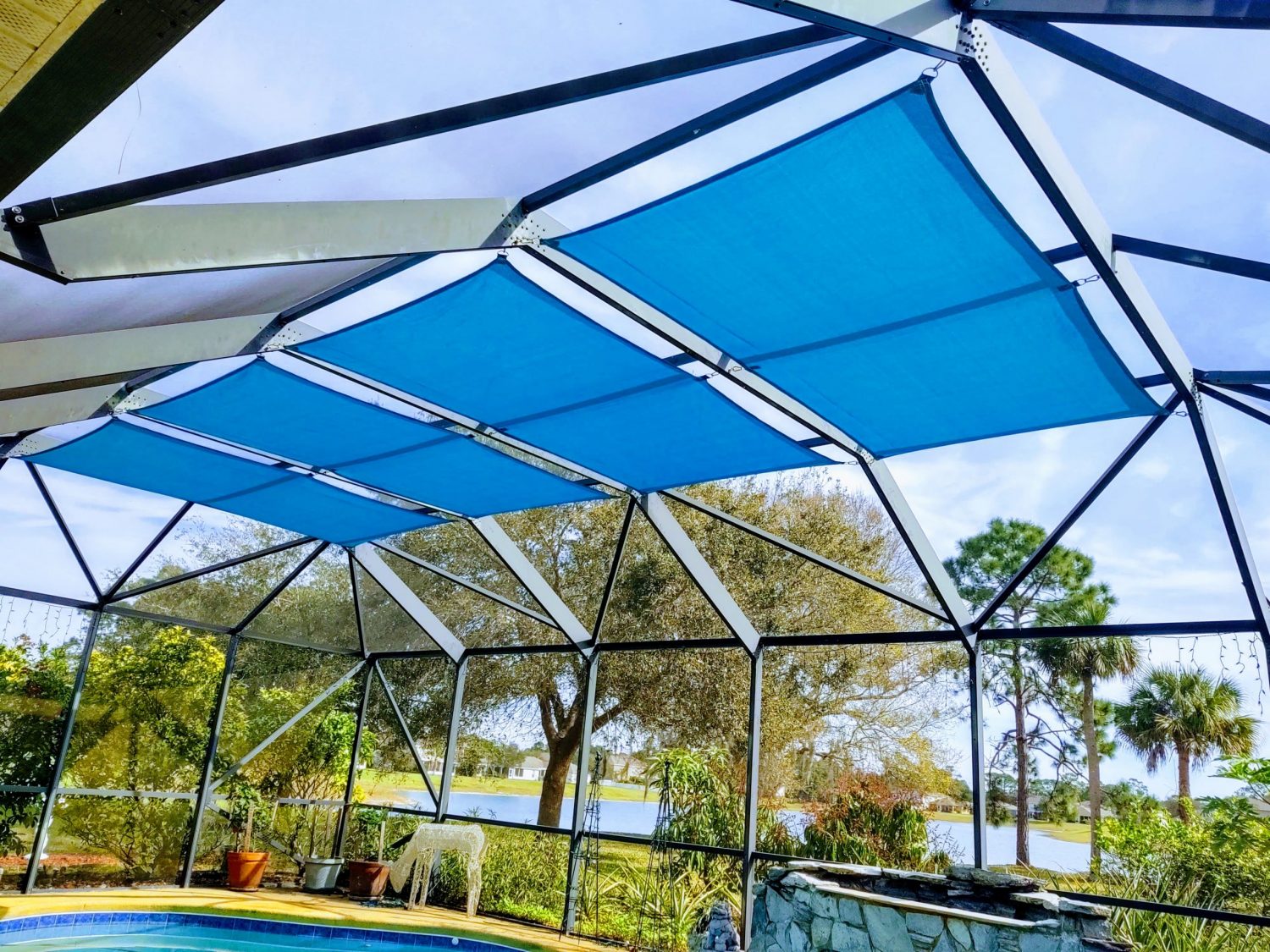 Blue shade sails on a Florida screen enclosure