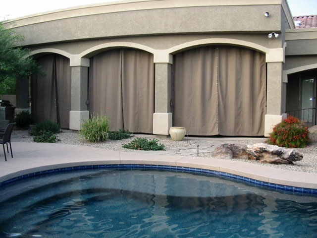 Private, shaded patio created with outdoor curtains