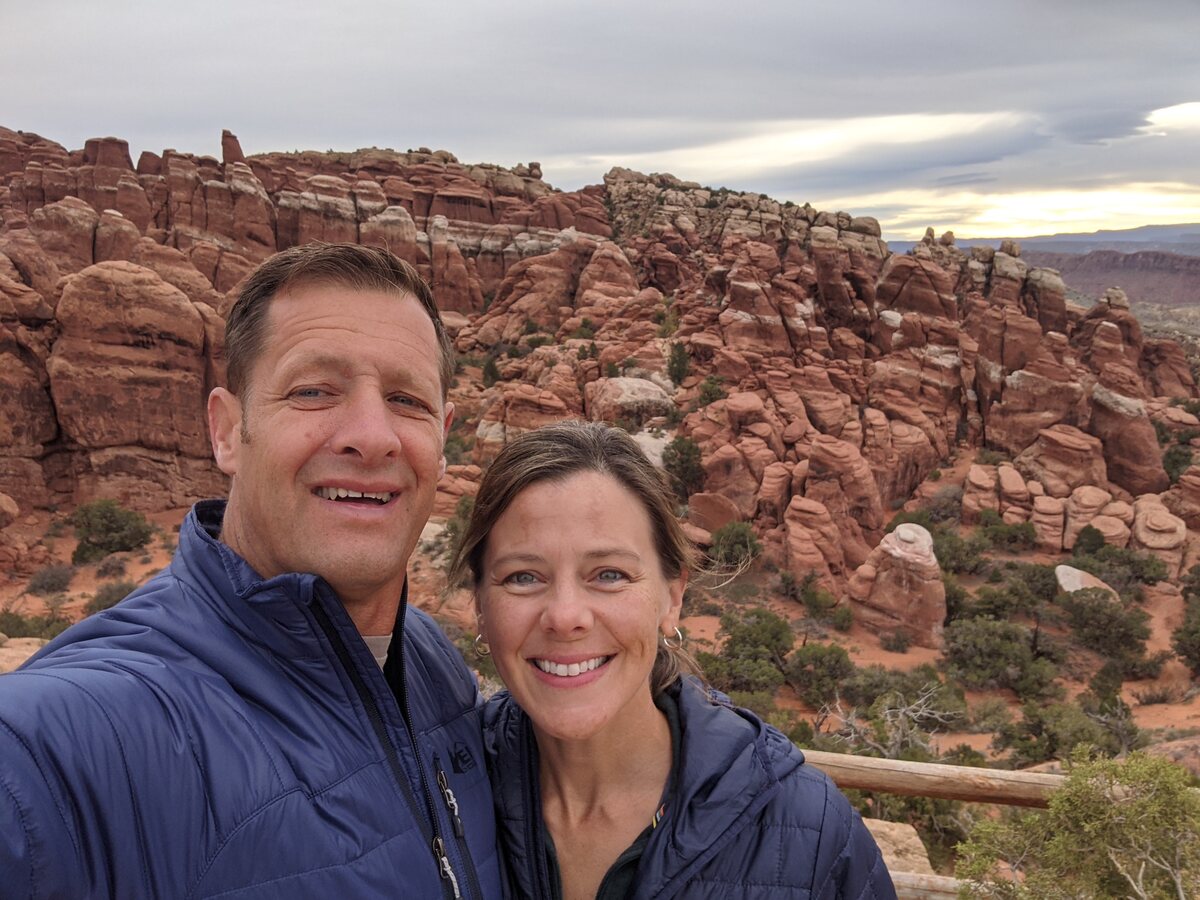 Merrill and Emily Burrows hiking among red rock formations