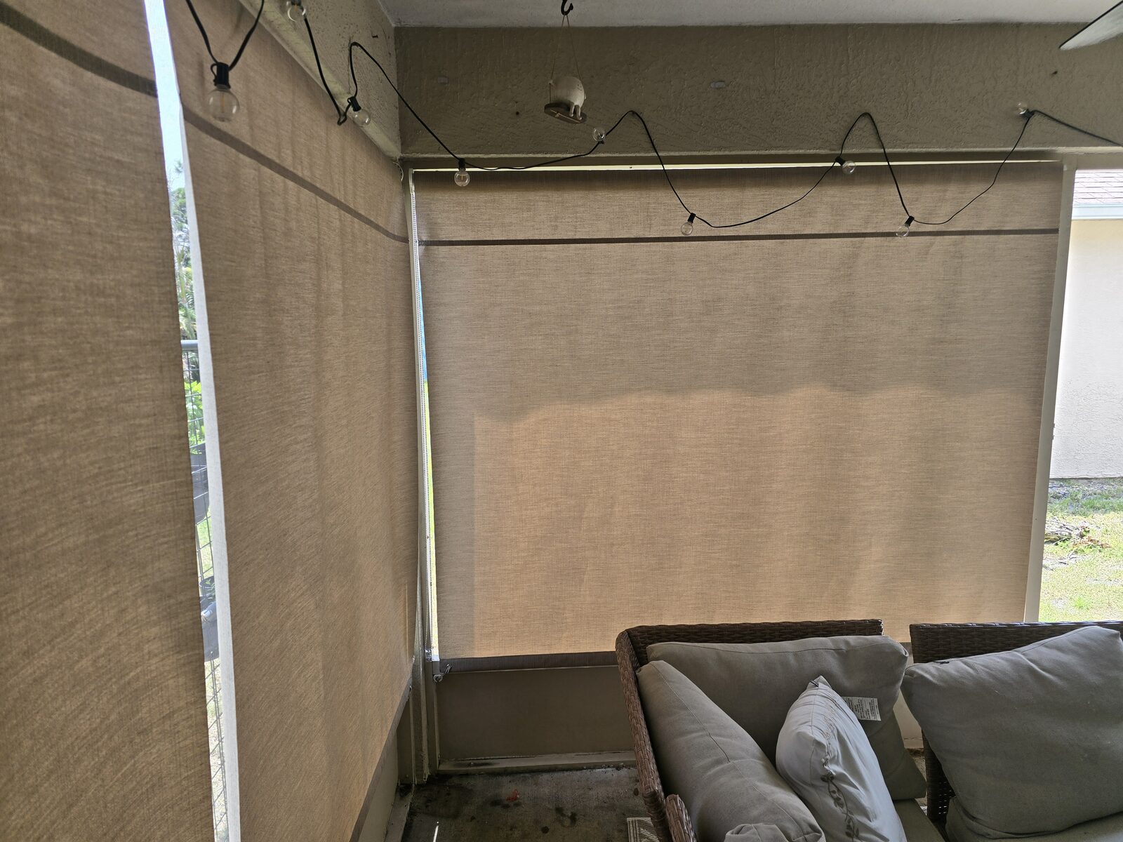 Outdoor rolldown shade lowered on a patio