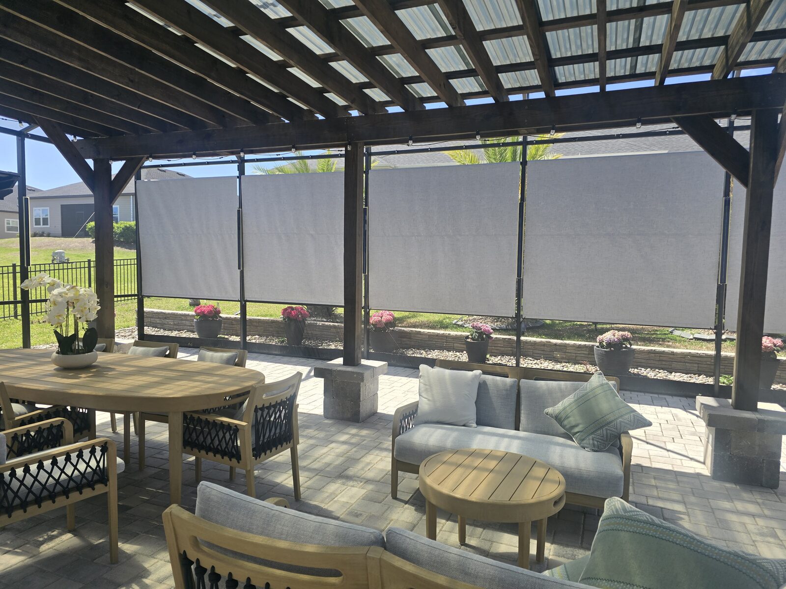 Rolldown shade lowered over a screened patio