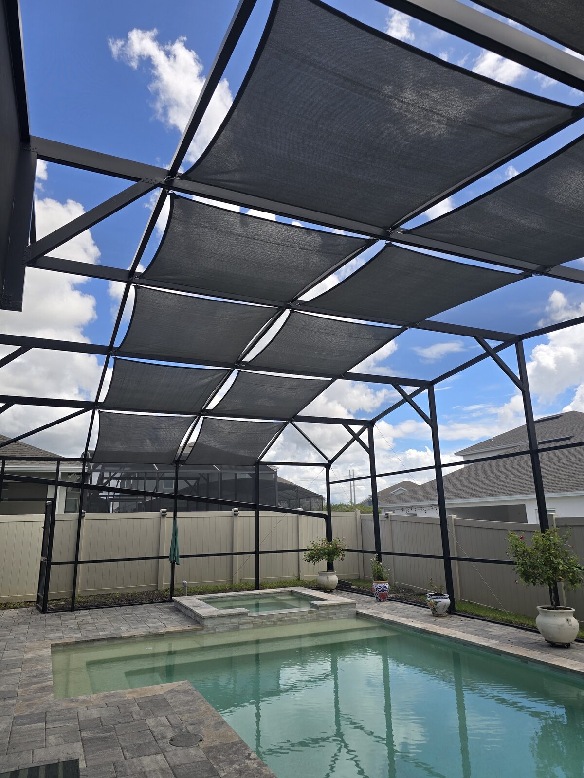 Outdoor shade sails shading a pool deck